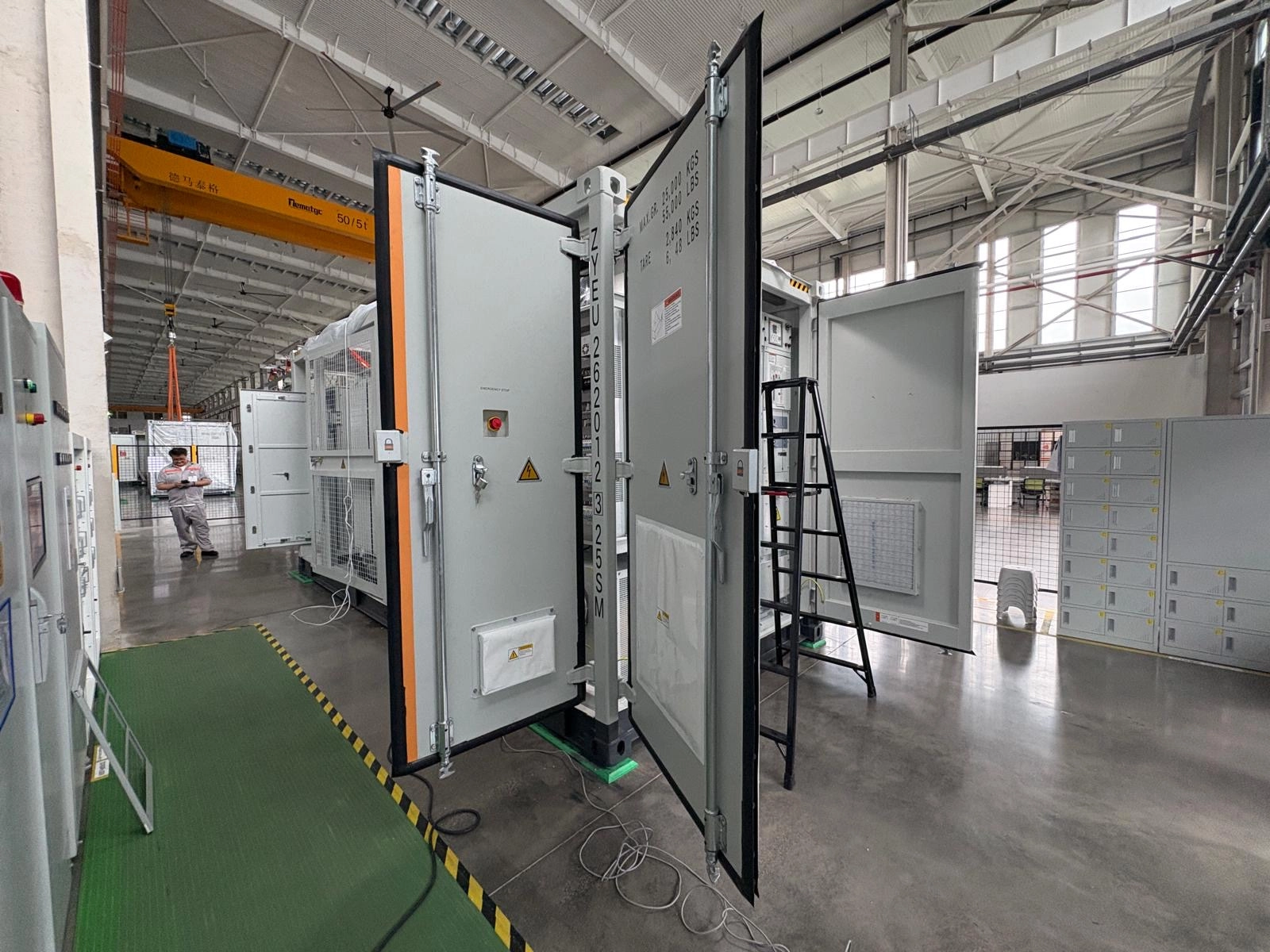 Open electrical equipment enclosure inside a factory