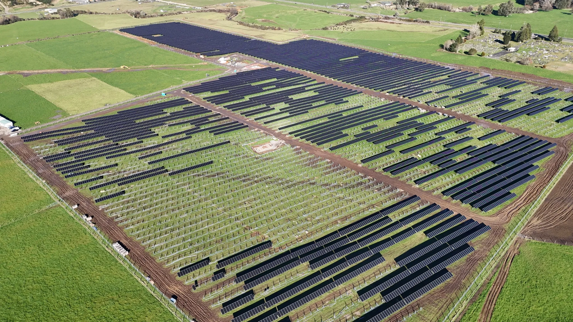 Wide aerial view of Reefton Solar Farm under construction across surrounding farmland
